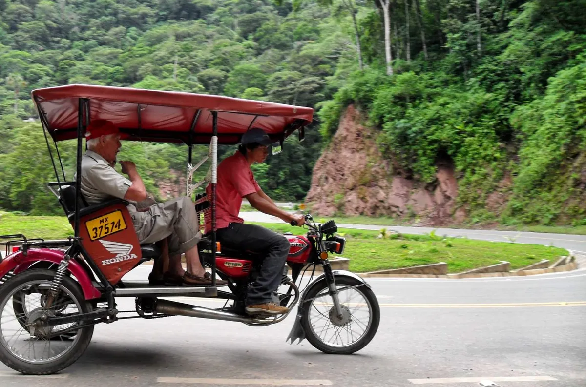 A mototaxi winding its way down a jungle road towards Tarapoto, Peru (with my dad in the back seat!). Photo by Tony Dunnell.